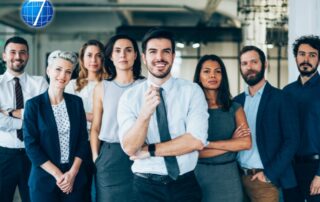 Leaders standing arms crossed in front of co-workers