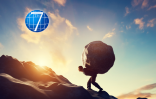 Man carrying heavy boulder while climbing a mountain