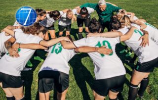 A sports coach huddling with a women's soccer team on a grassy field, emphasizing teamwork and strategy, symbolizing leadership lessons from sports.