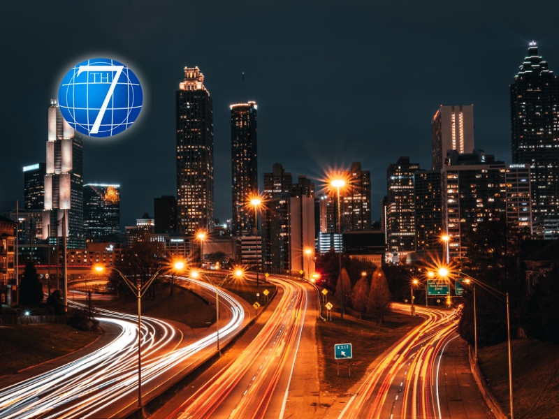 An illuminated cityscape at night with dynamic light trails from vehicles, symbolizing progress and adaptation, reflecting the essence of leadership strategies in navigating and thriving amidst disruption.
